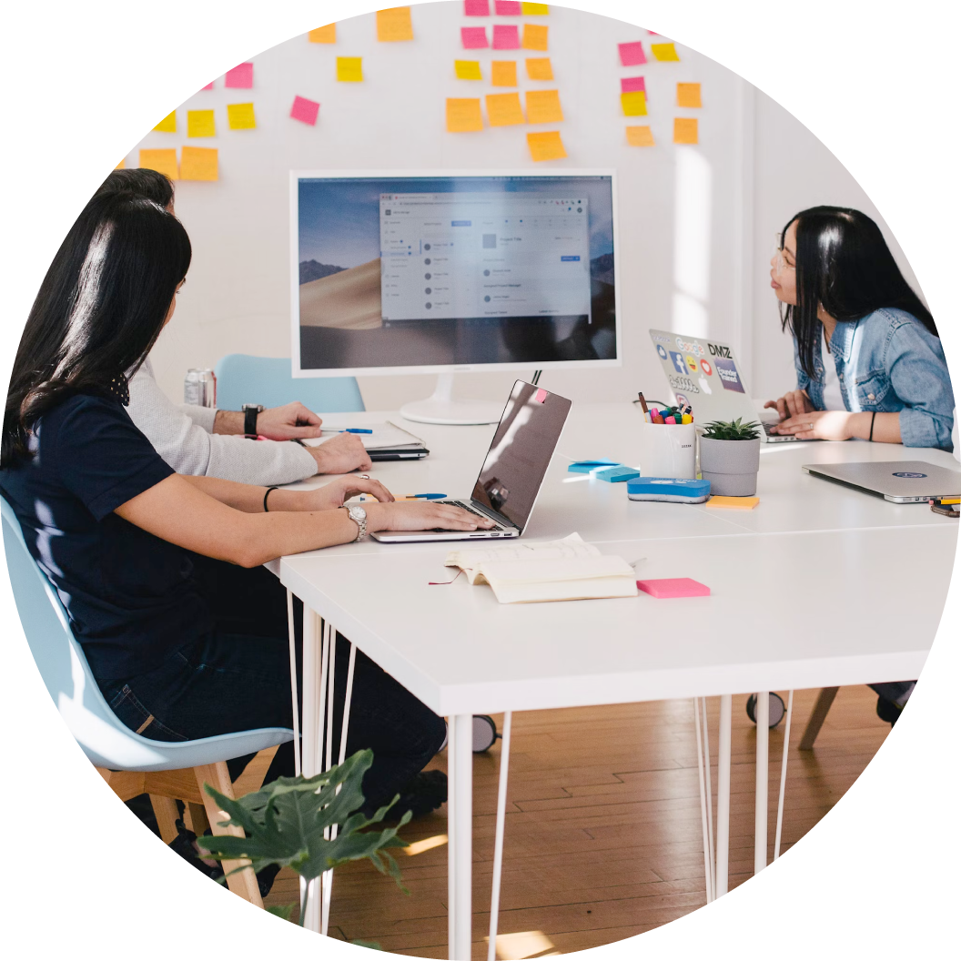 office workers with sticky notes in background at a meeting