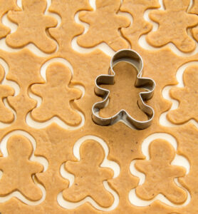 Surface full of gingerbread dough cut in man shape