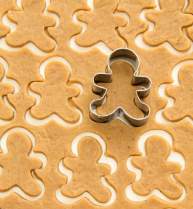 Surface full of gingerbread dough cut in man shape
